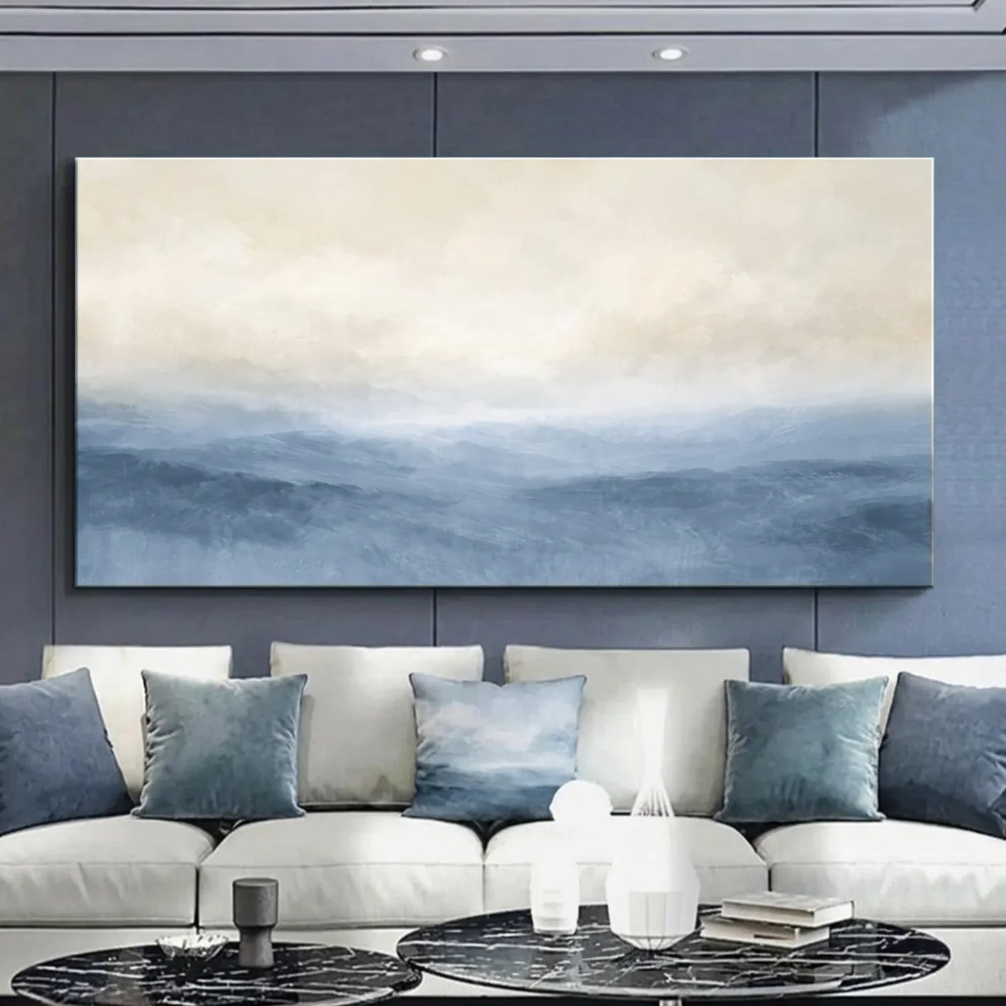 Modern living room with a large abstract painting on the wall above a white sofa with blue cushions. Muted Blue