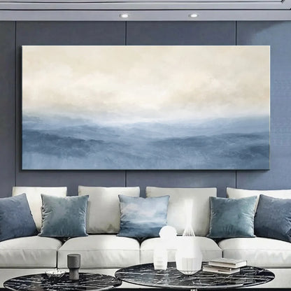 Modern living room with a large abstract painting on the wall above a white sofa with blue cushions. Muted Blue