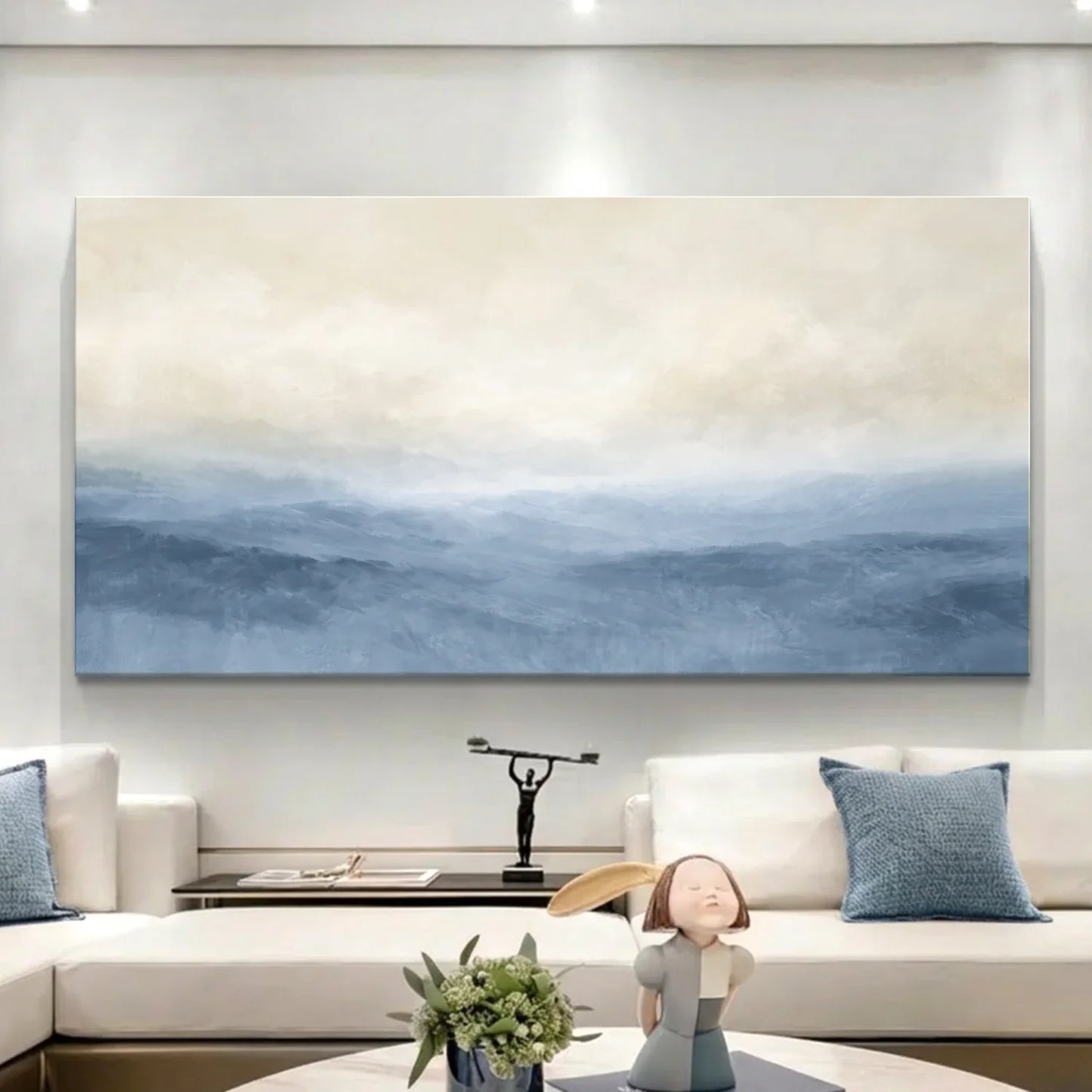 Modern living room with a large abstract painting on the wall, white sofa, and decorative items. Muted Blue