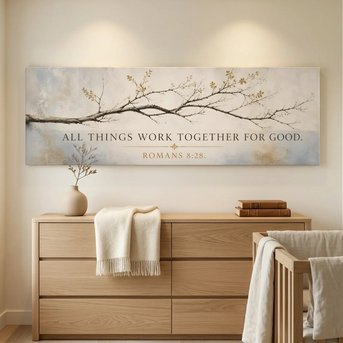 Nursery room with wooden dresser, crib, and decorative wall art with inspirational quote. All Things Work Together - Romans 8:28