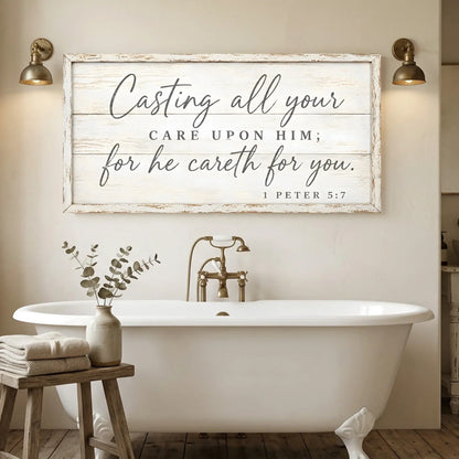 Bathroom with a freestanding bathtub, wooden stool with towels and plant, and a motivational quote sign on the wall. Casting All Your Care - 1 Peter 5:7