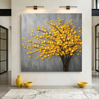 Decorative painting of a tree with yellow leaves on a gray background, displayed in a room with yellow vases and bowls.