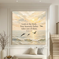 Framed artwork with a sunset over water and birds, featuring a religious quote, in a living room setting. Look At The Birds Your Heavenly Father Takes Care Of Them - Matthew 6:26