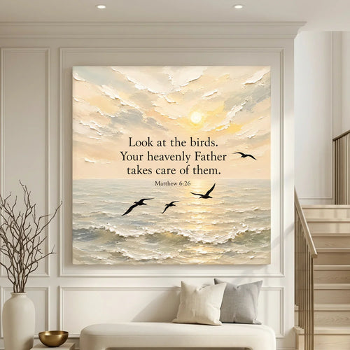 Framed artwork with a sunset over water and birds, featuring a religious quote, in a living room setting. Look At The Birds Your Heavenly Father Takes Care Of Them - Matthew 6:26