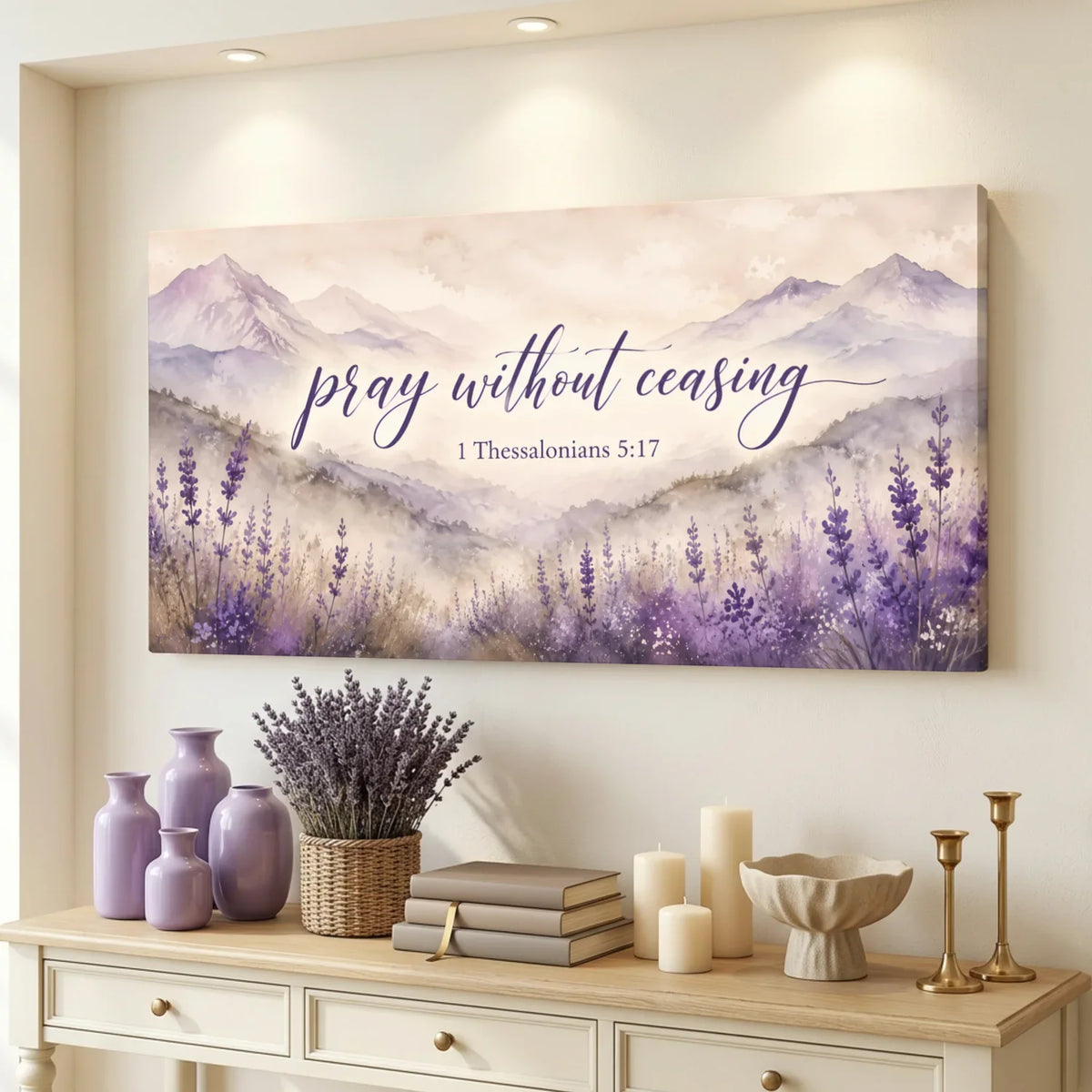 Decorative wall art with lavender and mountains on a wall above a console table with decor items.